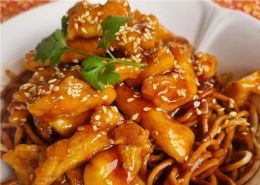 Sweet & sour chicken with sesame seeds and egg noodles
