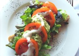 Avo Tomato Sandwich-avocado, tomato, sprouts on homemade brown bread and topped with a homemade creamy dressing.