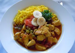 Chicken Curry served with turmeric rice, organic banana, chutney & coriander