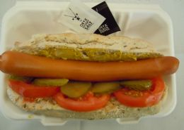Bockwurst on a gluten free roll with German mustard, gherkin and tomato